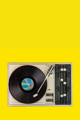 Wall Mural - Vintage turntable with spinning record on a yellow blank background