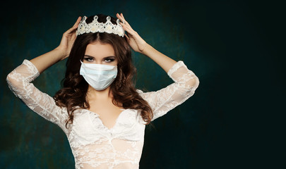 Perfect fashion woman in medical face mask and crown on dark green background