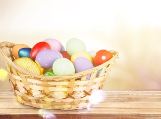 Poster - Colored easter eggs in the basket on the desk