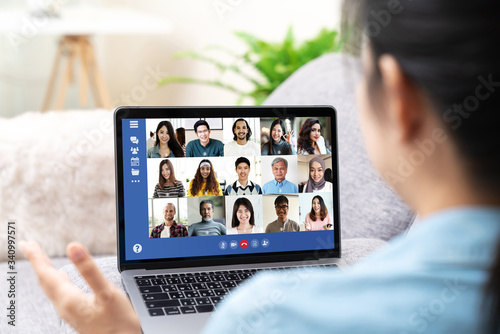 Cuadros en Lienzo Back view of young asian business woman work remotely at home video conference remote call to corporate group