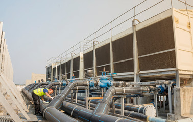 Wall Mural - Engineers inspect machine operations. Cooling towers in large buildings For safety