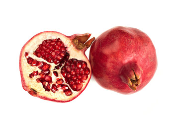 Wall Mural - two ripe bright pomegranates on a white table