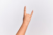 © Krakenimages.com - Hand of caucasian young woman gesturing rock and roll symbol, showing obscene horns gesture