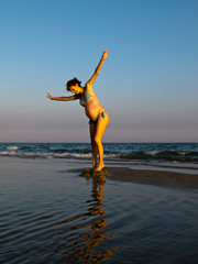 Pregnant woman plays in the water