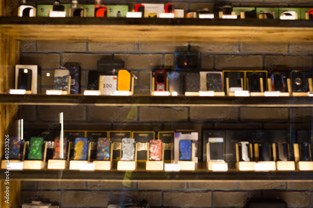 Blurry showcase in vape shop close up. Blurred showcase with the goods.  Stock Photo