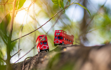 toys that represent two of the main symbols of the city of London, double-decker bus on blurred background. selective focus and grain nose.