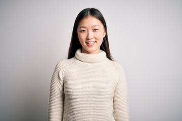 Wall Mural - Young beautiful asian woman wearing casual sweater standing over isolated background with a happy and cool smile on face. Lucky person.