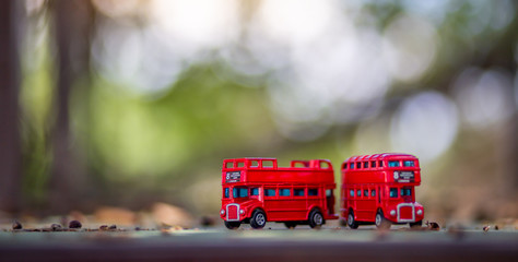 toys that represent two of the main symbols of the city of London, double-decker bus on blurred background. selective focus and grain nose.