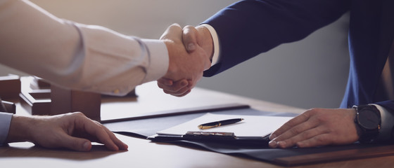 Wall Mural - Male lawyer shaking hands with client in office, closeup. Banner design