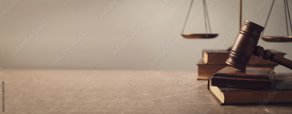Wooden gavel with scales of justice and books on lawyer's table, space for text. Banner design - obrazy, fototapety, plakaty 