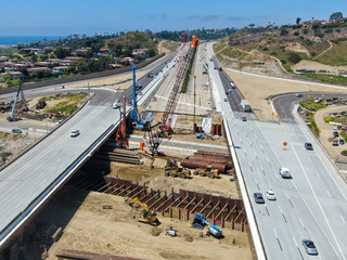 Aerial view of highway bridge construction over small river, San Diego, California, USA