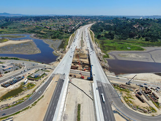 Aerial view of highway bridge construction over small river, San Diego, California, USA