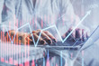 © peshkova - Double exposure of woman hands typing on computer and forex chart hologram drawing. Stock market invest concept.