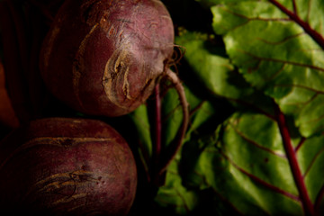 Wall Mural - Fresh organic beetroot with their leaves on a wooden table