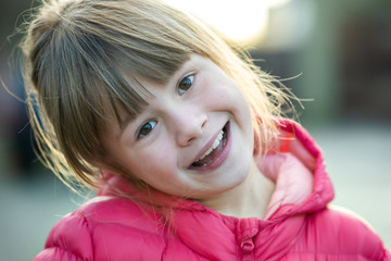 Wall Mural - Portrait of a pretty child girl outdoors on a sunny warm autumn day.