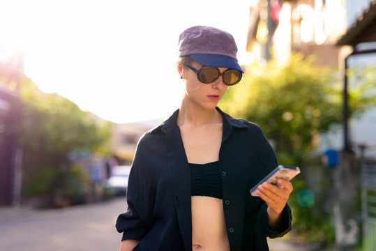 Portrait of young beautiful woman in the city streets outdoors