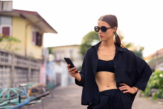 Portrait of young beautiful woman in the city streets outdoors