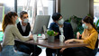 © godji10 - Businessman and women working together in public places on a day that covid 19 virus are epidemics. They wear surgical masks to prevent the outbreak of corona virus, influenza or dust allergy.