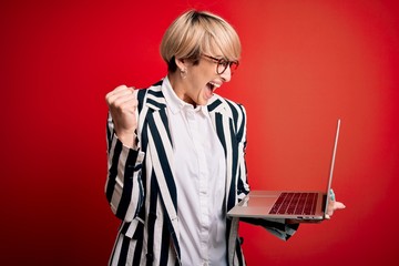 Sticker - Young blonde business woman with short hair wearing glasses working using computer laptop screaming proud and celebrating victory and success very excited, cheering emotion