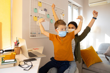 Wall Mural - Mother and son ready to fight dangerous virus stock photo