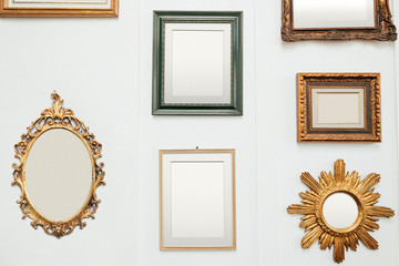 Wall Mural - Golden frames on a wall mockup