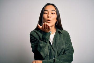 Sticker - Young beautiful asian woman wearing casual shirt standing over isolated white background looking at the camera blowing a kiss with hand on air being lovely and sexy. Love expression.