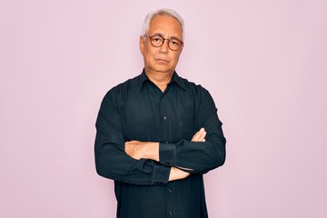 Sticker - Middle age senior grey-haired handsome man wearing glasses and elegant shirt skeptic and nervous, disapproving expression on face with crossed arms. Negative person.