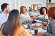 © Krakenimages.com - Group of business workers smiling happy and confident. Working together with smile on face shaking hands at the office