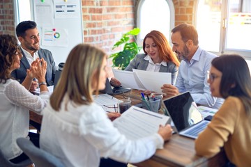 Wall Mural - Group of business workers working together. Sitting on desk using laptop reading documents at the office