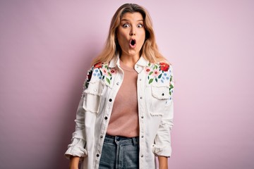 Sticker - Young beautiful blonde woman wearing casual jacket standing over isolated pink background afraid and shocked with surprise expression, fear and excited face.