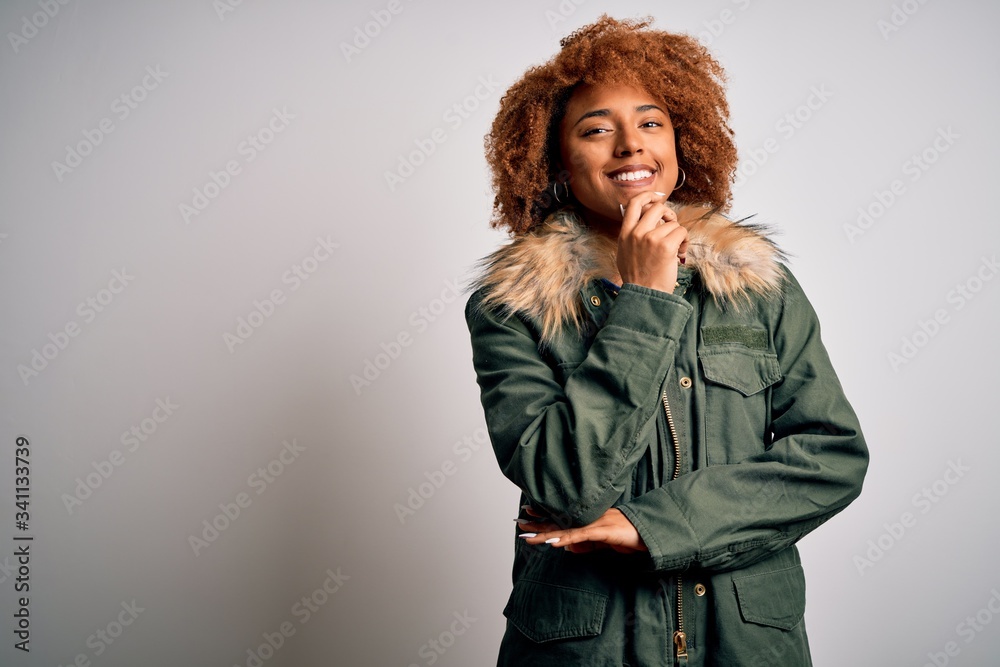 Young beautiful African American woman with curly hair wearing green ...
