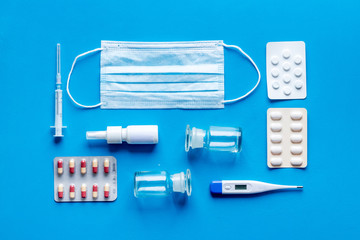 Cold, flu and virus treatment - flat lay with medicine - on blue background top view