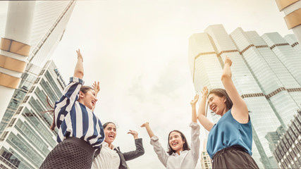 Business team raising hands up, expressing happiness and rejoice with success