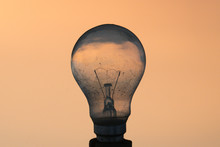 A Closeup Picture Of A Electric Light Bulb With Diffuse Colorful Background