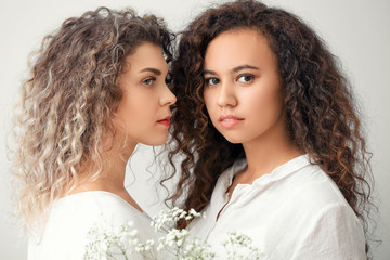 Wall Mural - Beautiful young women on light background