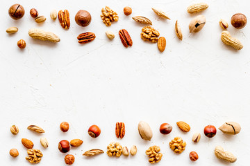 Wall Mural - Nuts background - healthy snacks concept - on white table top-down frame copy space