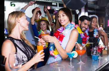 Wall Mural - Women drinking cocktails in nightclub