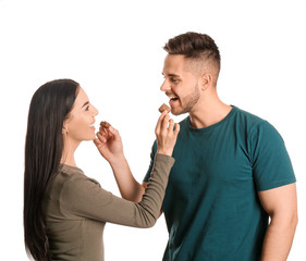 Wall Mural - Beautiful young couple with tasty chocolate on white background