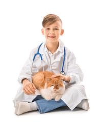 Poster - Little veterinarian with cute cat on white background