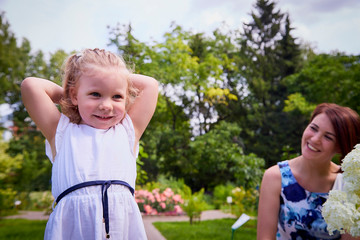 Happy mother and daughter in the park. Beauty nature scene with family outdoor lifestyle. Family resting outdoor