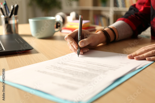 Cuadros en Lienzo Student girl hand signing contract at night