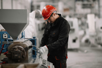 Wall Mural - Portrait of worker in factory. Young handsome man working in factory.	