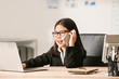 © Pixel-Shot - Cute little businesswoman talking by mobile phone in office