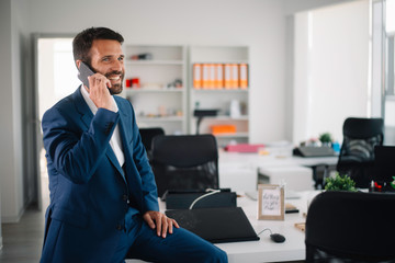 Young businessman working in office. Handsome man preparing for the meeting.