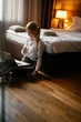 © JustLife - Businesswoman working on lap top. Young beautiful woman working in hotel room.