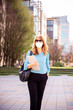 © sepy - Portrait shot of confident businesswoman wearing face mask while going to work during coronavirus pandemic