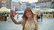 © art24pro - Woman taking selfie on square. Attractive woman posing for selfie and standing on city square.