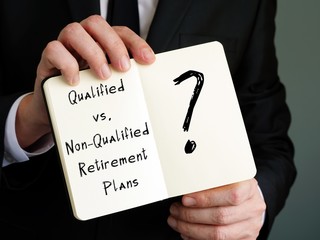 The caption in the picture is Qualified vs. Non-Qualified Retirement Plans. Notebook sheet, table, pens.