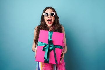 Canvas Print - Photo of delighted young woman in sunglasses posing with gift box