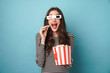 © Drobot Dean - Photo of excited young woman eating popcorn while watching movie
